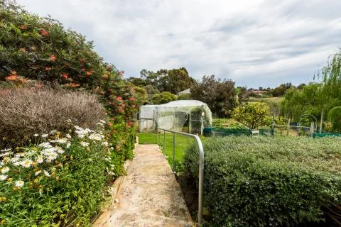 Steps past garden bed to vegetable garden 스톡 사진