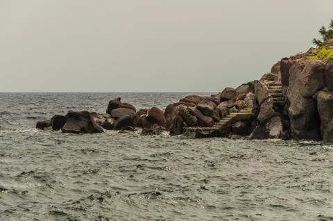 Steps of small pier between the rocks Stock Photos