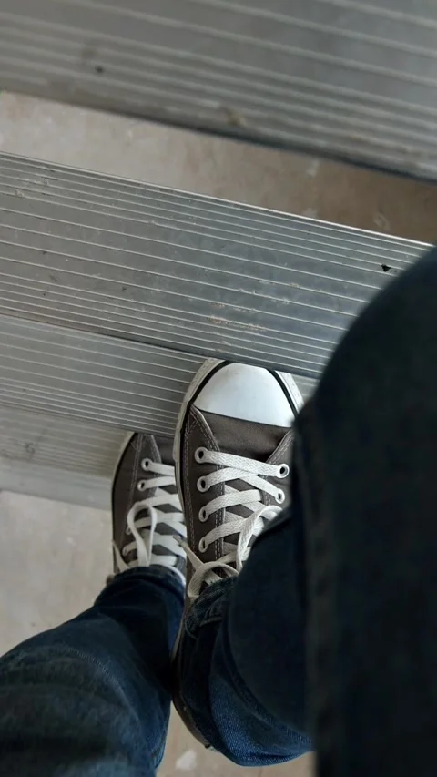 Steps of a stepladder, on which a man in sneakers Stock Footage 304957758