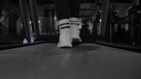 Steps on a treadmill close-up, white sneakers Stock Footage 125907296