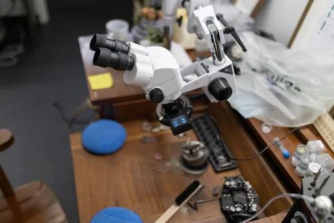 Stereo microscope on workbench in jewelry workshop Stock Photos