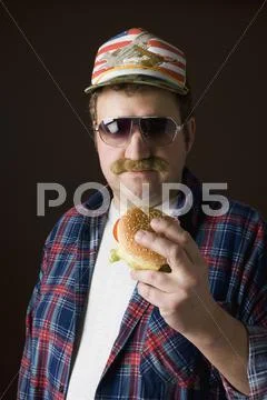Stereotypical American man holding a hamburger Stock Photos
