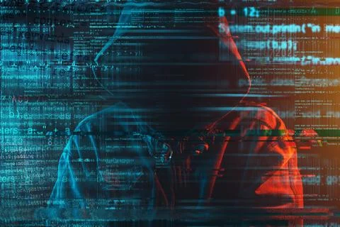Stereotypical image of computer hacker with hoodie and computer code Stockfoto's