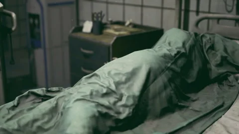 Sterile and decayed morgue environment with forensic technician presence Stock Footage 341826654