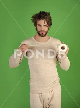 Sterility and purity. Man with serious face hold toilet paper, single. Stock Photos