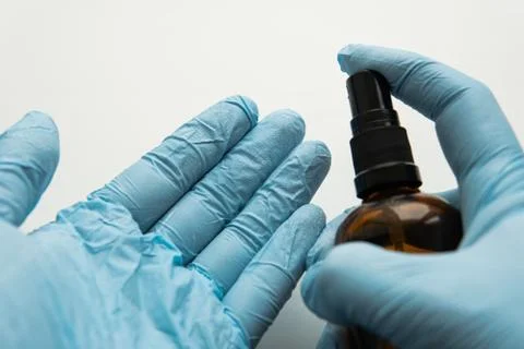 Sterilization of hands with protective blue gloves. .basic defenses during th Stock Photos