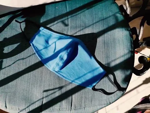 Sterilizing a mask with the sun during coronavirus at Christmas time Stock Footage 145027147