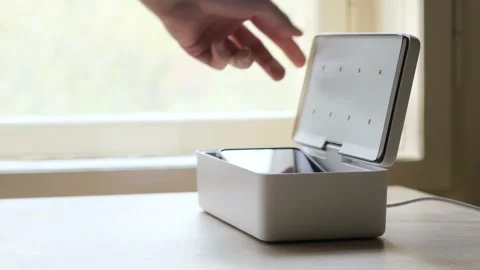 Sterilizing phone in a UV sterilization box slow motion Video stock 152929589