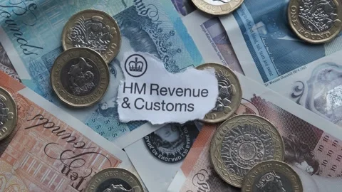 Sterling bank notes and pound coins cash. With words HM Revenue and Customs Stock Footage 263822172