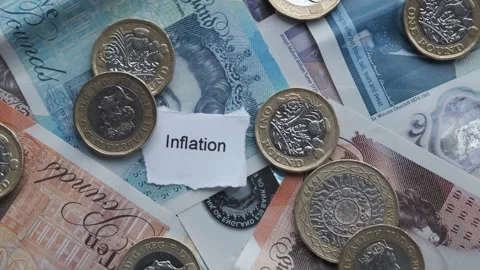 Sterling bank notes and pound coins cash. With word Inflation Stock Footage 263822173