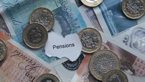 Sterling bank notes and pound coins cash. With word Pensions Stock Footage 263822174