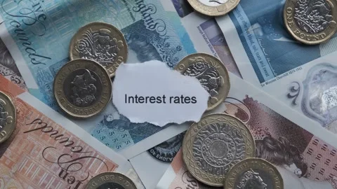 Sterling bank notes and pound coins cash. With words Interest Rates Stock Footage 263822475