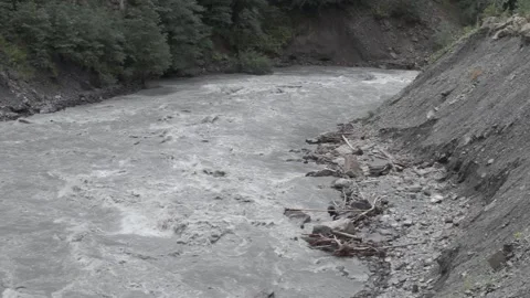 The stern current of a cold mountain river with a stony shore Stock Footage 94260401