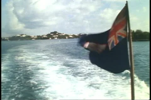 Stern of Ferry boat, no people, flag waving, choppy wash, Bermuda Stock Footage