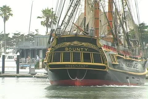 Stern of HMS Bounty backing up from dock into channel Stock Footage 12436657