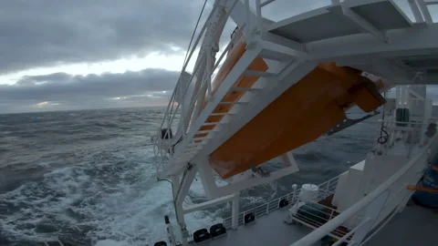 Stern of ship in storm. Free fall on cargo vessel. Big waves behind Stock Footage 255156892