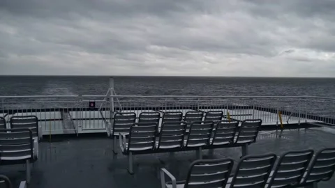 Stern view of ferry boat with empty seats on Inside Passage, Canada in autumn Stock Footage 166338964
