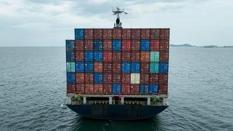 Stern View Of Large Cargo Ship Navigating Open Waters High Angle Shot Stock Photos