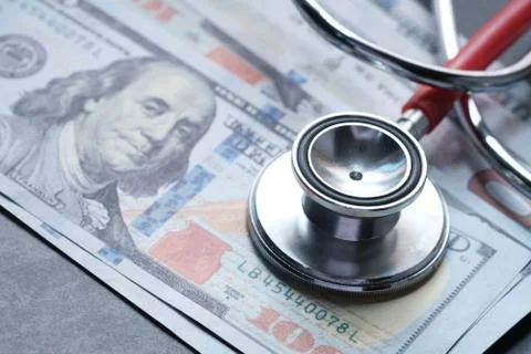 Stethoscope on american money, High Cost of Health Insurance. Stock Photos