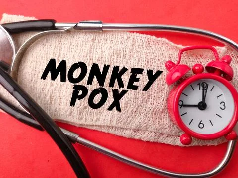 Stethoscope and clock with the word MONKEY POX Stock Photos