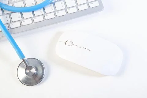 Stethoscope and computer mouse on white background. Medical equipment. Stock Photos