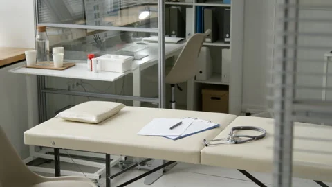 Stethoscope and Documents Resting on Examination Table in Private Area of Clinic Stock Footage 333197171
