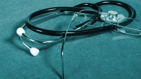 Stethoscope and glasses on table Stock Footage 70748207