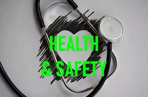 Stethoscope and heart-shaped shadow with the words health and safety Stock Photos