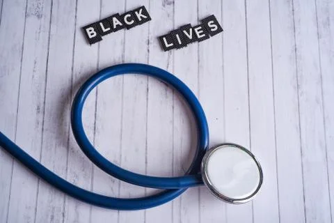 Stethoscope and inscription black lives on a white wood background Stock Photos