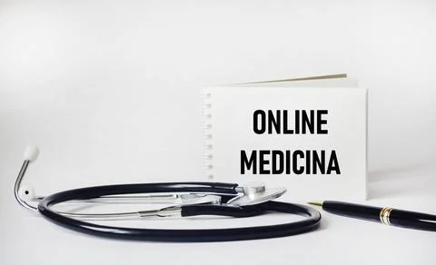 Stethoscope and a notepad on a white background with the inscription Online.. Stock Photos