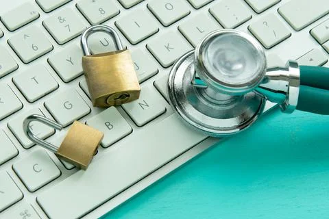 Stethoscope and padlock on a computer keyboard Stock Photos