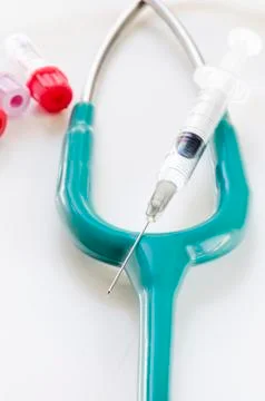 Stethoscope and syring Stock Photos