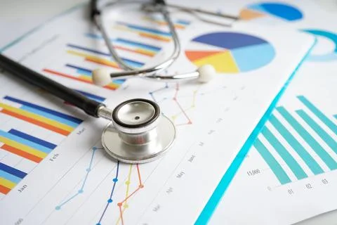 Stethoscope and US dollar banknotes on chart or graph paper, Financial, acc.. Stock Photos
