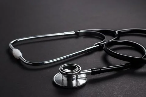Stethoscope on black background with space for text - health concept. Medic.. Stockfoto's