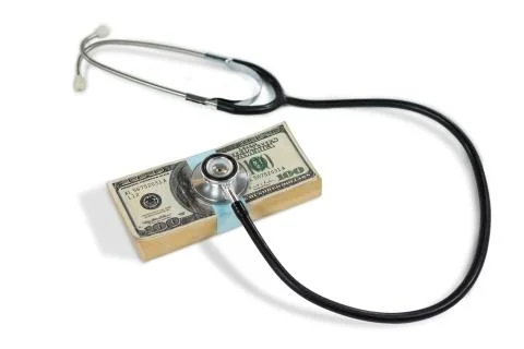 Stethoscope on bundle of currency note Stock Photos