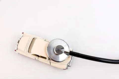 Stethoscope checking up the car on a white background. Concept of car check u Stock Photos