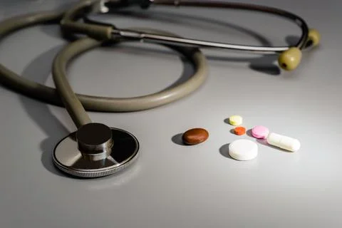 Stethoscope close-up. Next to tablets and capsules, the diagnosis result is Stock Photos