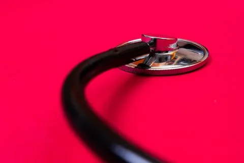 Stethoscope close-up on red background. Stock Photos