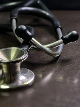 Stethoscope Closeup on Dark Surface in Soft Focus Stock Photos