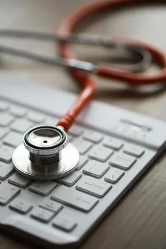 Stethoscope on Computer Keyboard: Medical Technology in Healthcare Stock Photos