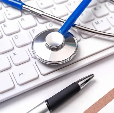Stethoscope on computer keyboard on white background. Physician write medical Stock Photos