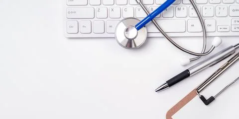 Stethoscope on computer keyboard on white background. Physician write medical 写真素材
