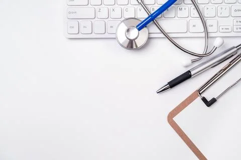 Stethoscope on computer keyboard on white background. Physician write medic.. Stock Photos
