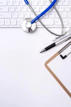Stethoscope on computer keyboard on white background. Physician write medic.. Stock Photos