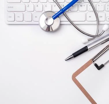 Stethoscope on computer keyboard on white background. Physician write medic.. Stock Photos