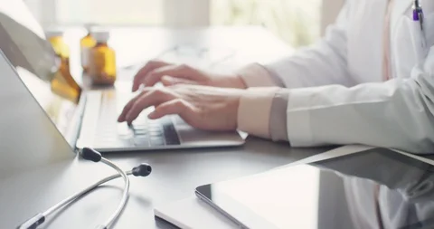 Stethoscope, Digital Tablet And Notepad By Doctor Using Laptop 4K Stock Footage 92366005