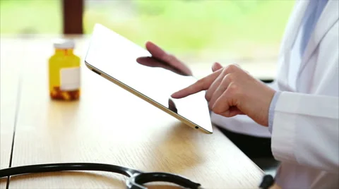 Stethoscope with doctor using tablet PC in medical clinic Stock Footage 53880384