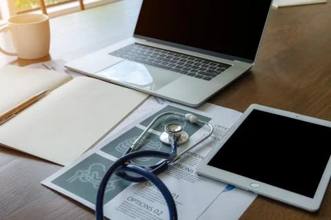 Stethoscope in doctors desk. Stock Photos