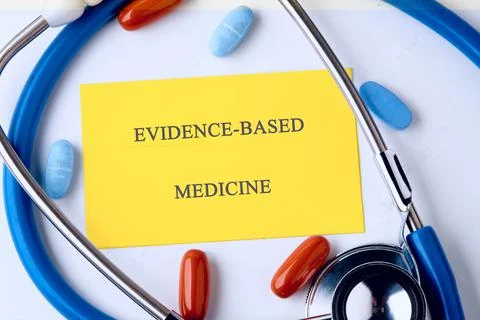 A stethoscope frames a yellow note that reads evidence based medicine, surrou Stock Photos