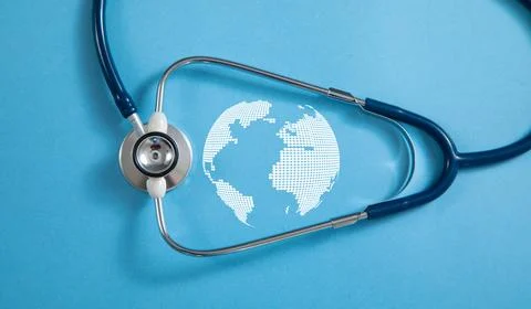 Stethoscope with a globe on the blue background. Stock Photos